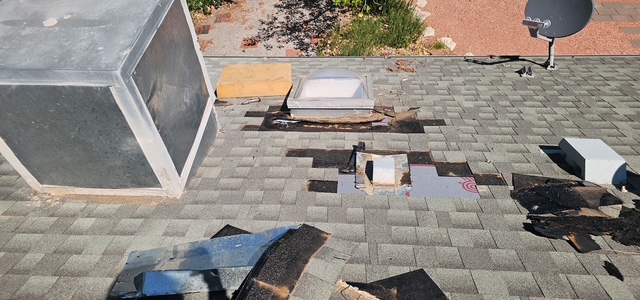 Storm damaged shingles and exposed underlayment
