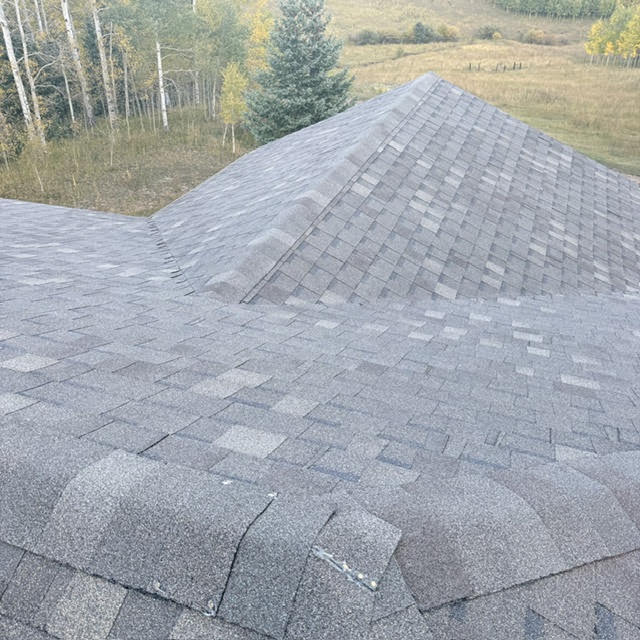 Impact resistant asphalt shingle roofing